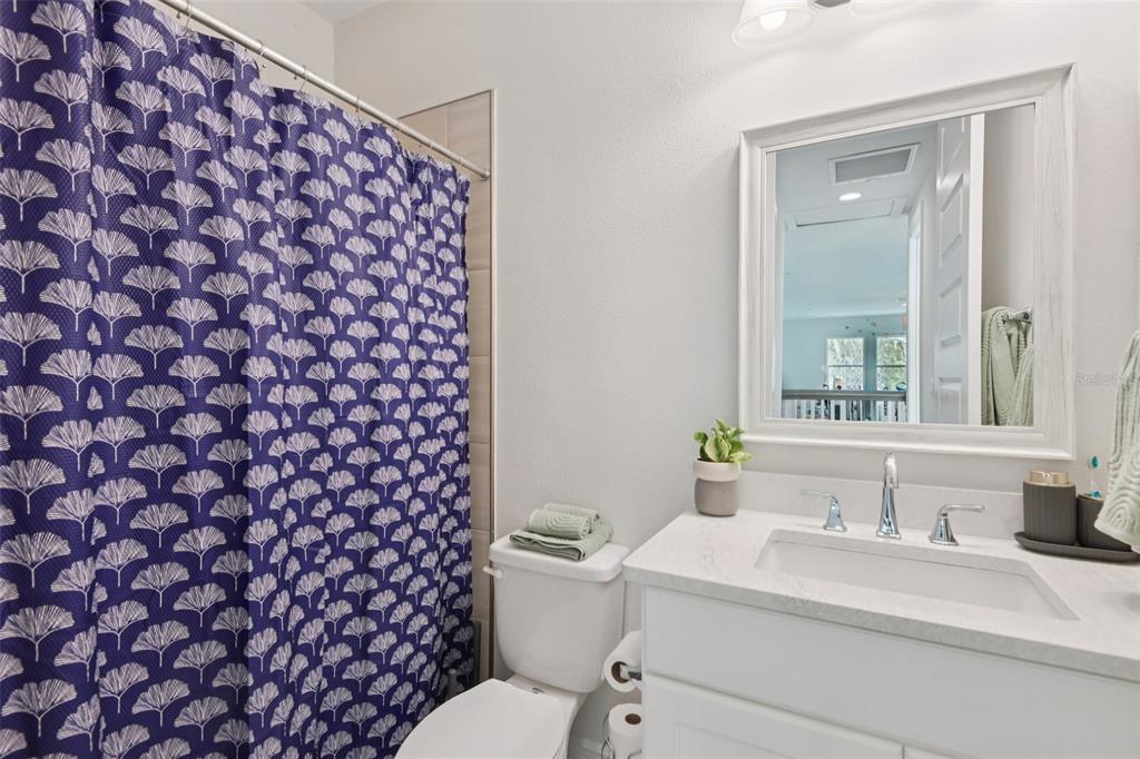 2304 Clement Road Lutz, FL 33549 - Photo 26 of 37 a bathroom with a granite countertop toilet a sink and a mirror