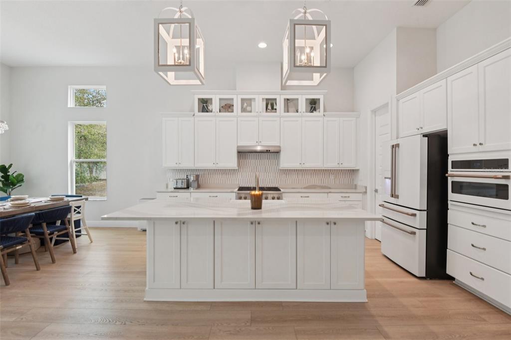 2304 Clement Road Lutz, FL 33549 - Photo 4 of 35 a kitchen with stainless steel appliances a sink and cabinets