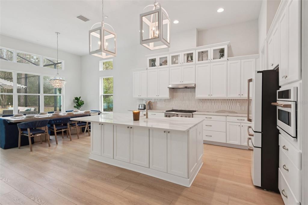 2304 Clement Road Lutz, FL 33549 - Photo 7 of 37 a kitchen with cabinets appliances and a dining table