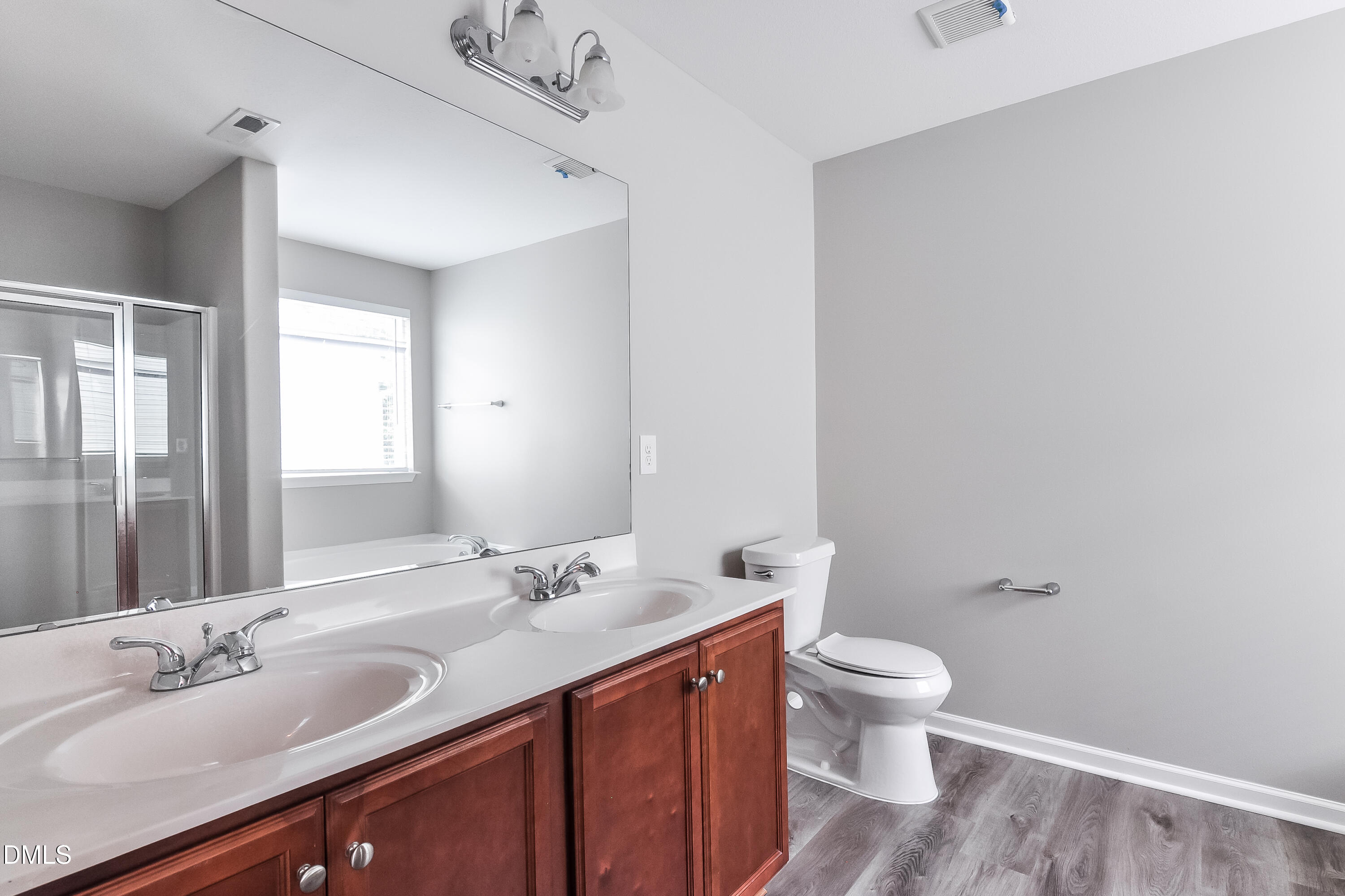817 Leatherstone Lane Fuquay-Varina, NC 27526 - Photo 11 of 17 a bathroom with a double vanity sink toilet and a mirror