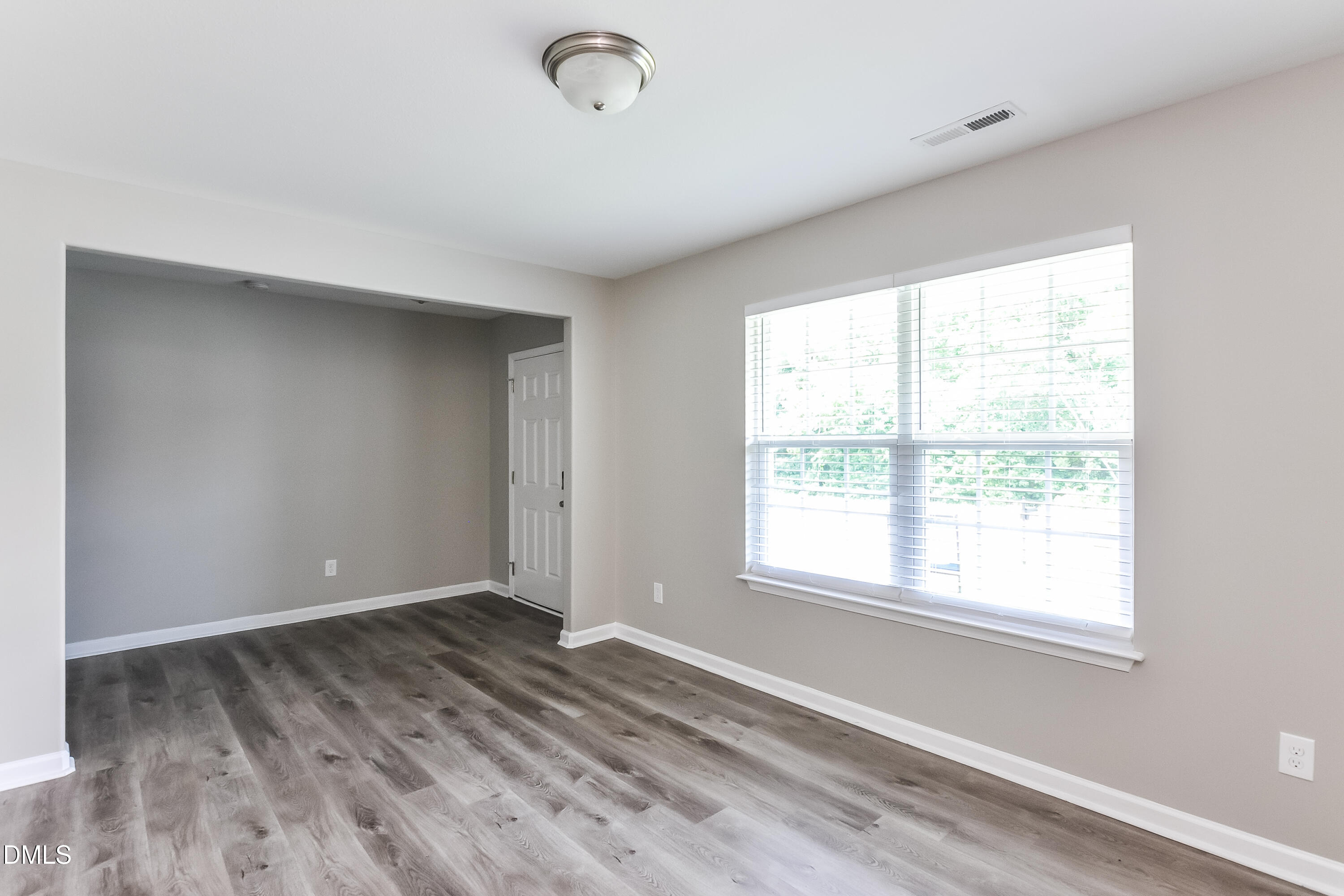 817 Leatherstone Lane Fuquay-Varina, NC 27526 - Photo 2 of 17 a view of an empty room with wooden floor and a window