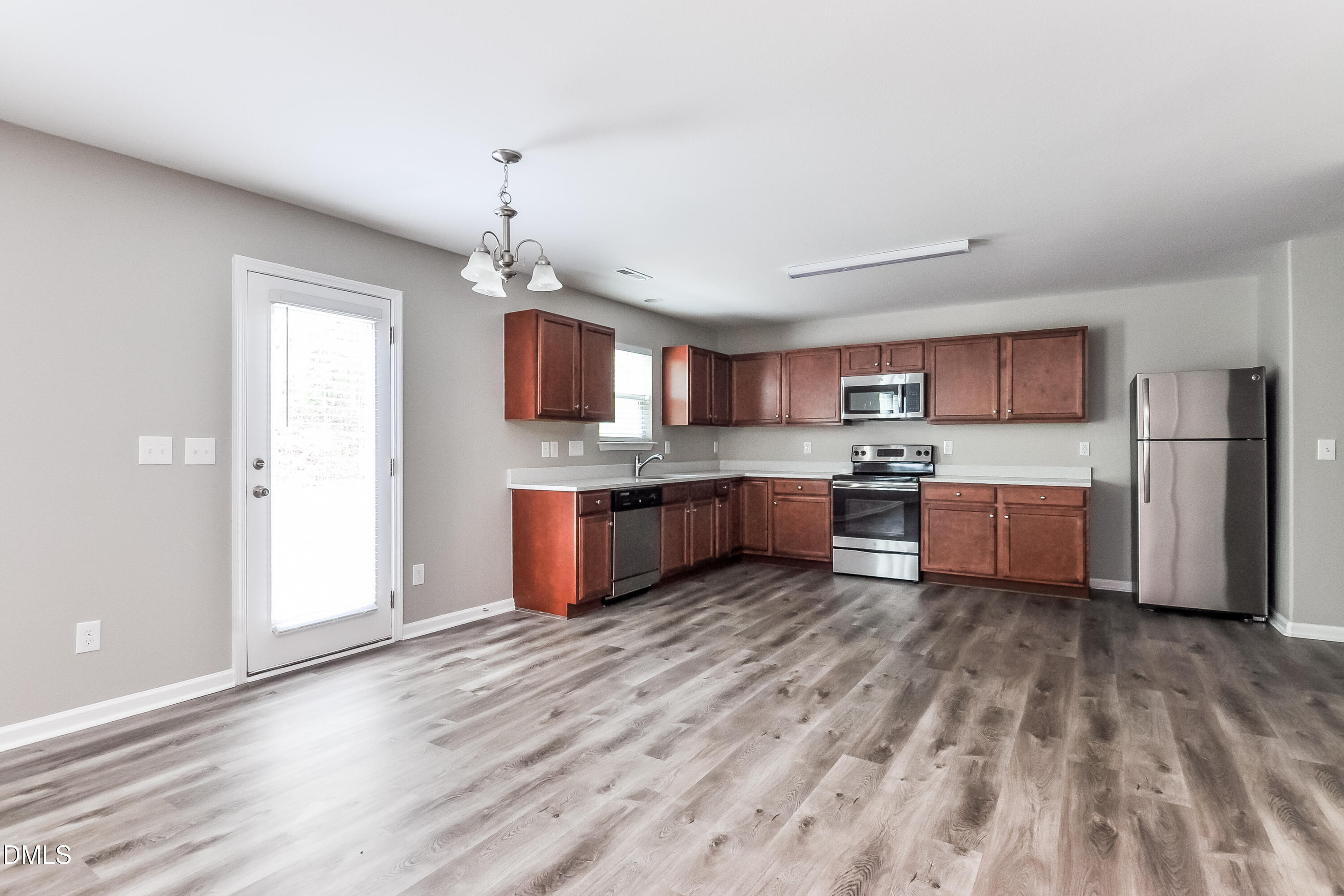 817 Leatherstone Lane Fuquay-Varina, NC 27526 - Photo 5 of 17 a view of kitchen with granite countertop cabinets and refrigerator