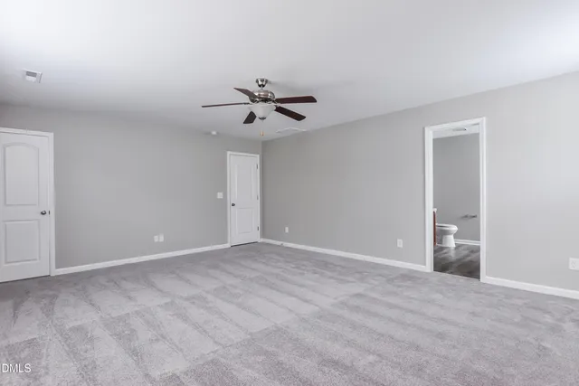 a view of an empty room with a ceiling fan