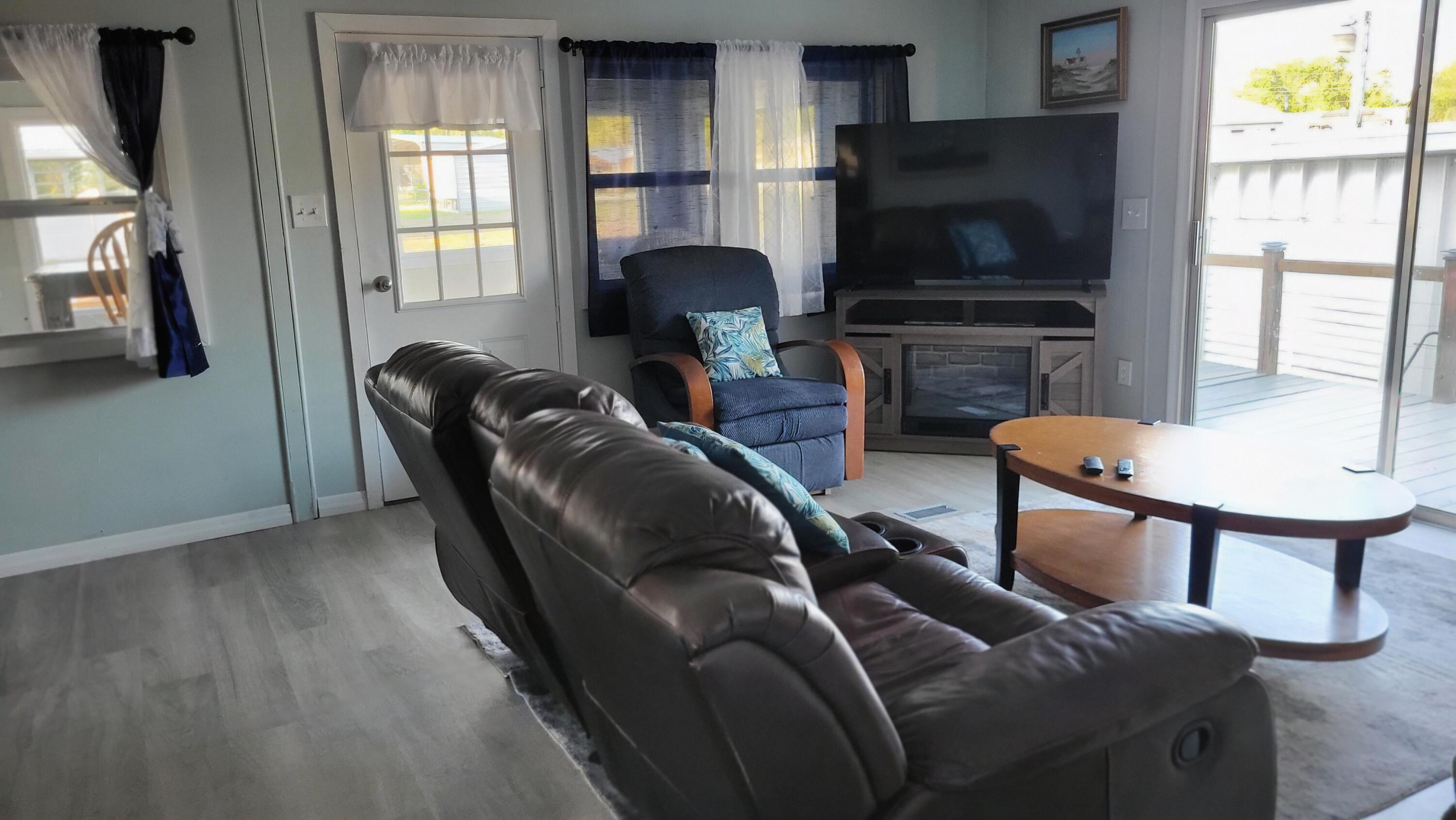 1982 Linda Road Okeechobee, FL 34974 - Photo 31 of 43 a living room with furniture and a flat screen tv