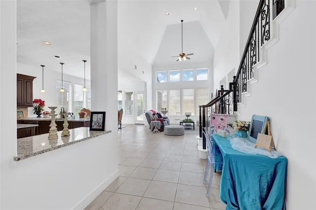 a living room with furniture kitchen view and a wooden floor