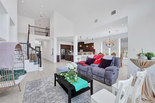 a dining room with furniture a chandelier and wooden floor