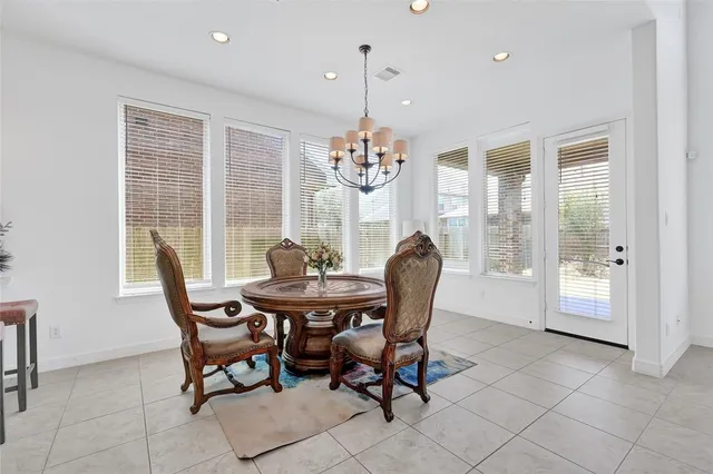 a kitchen with stainless steel appliances granite countertop a kitchen island a stove a refrigerator and a sink