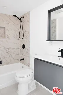 a bathroom with a toilet sink and shower