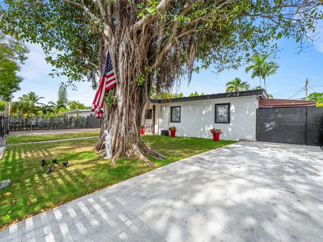 a front view of house with yard and green space