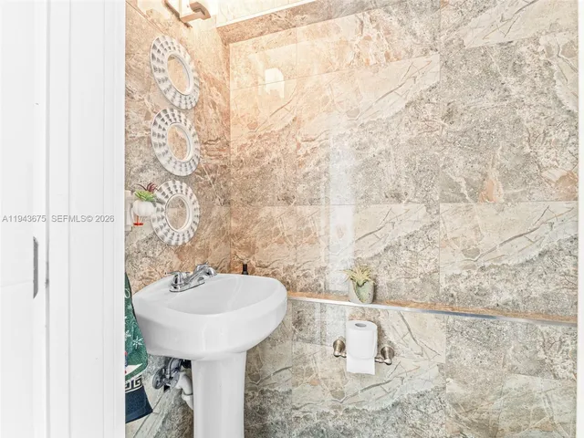 a kitchen with stainless steel appliances kitchen island granite countertop a stove and a large window