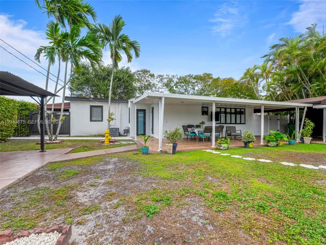 a view of a backyard with plants and a patio
