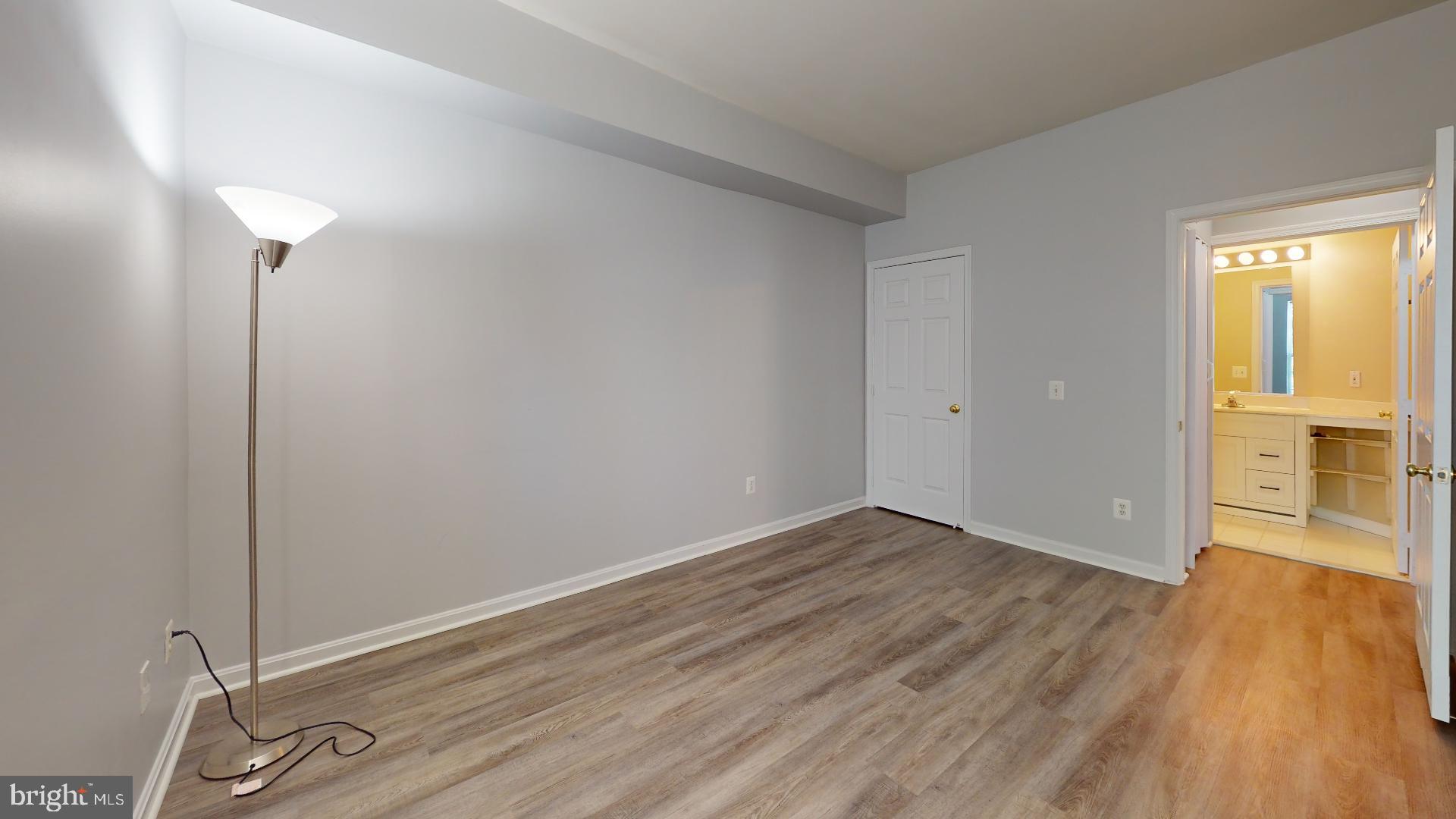 5947 Founders Hill Drive, Unit 103 Alexandria, VA 22310 - Photo 16 of 19 an empty room with wooden floor and windows