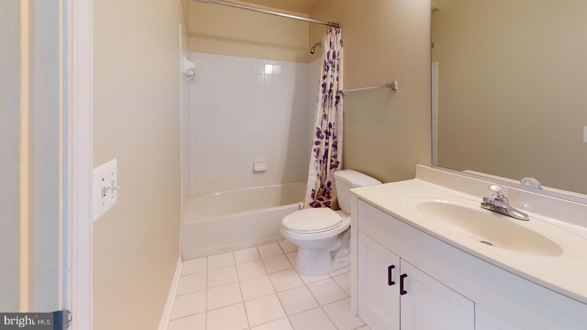 5947 Founders Hill Drive, Unit 103 Alexandria, VA 22310 - Photo 18 of 19 a bathroom with a sink a toilet and shower