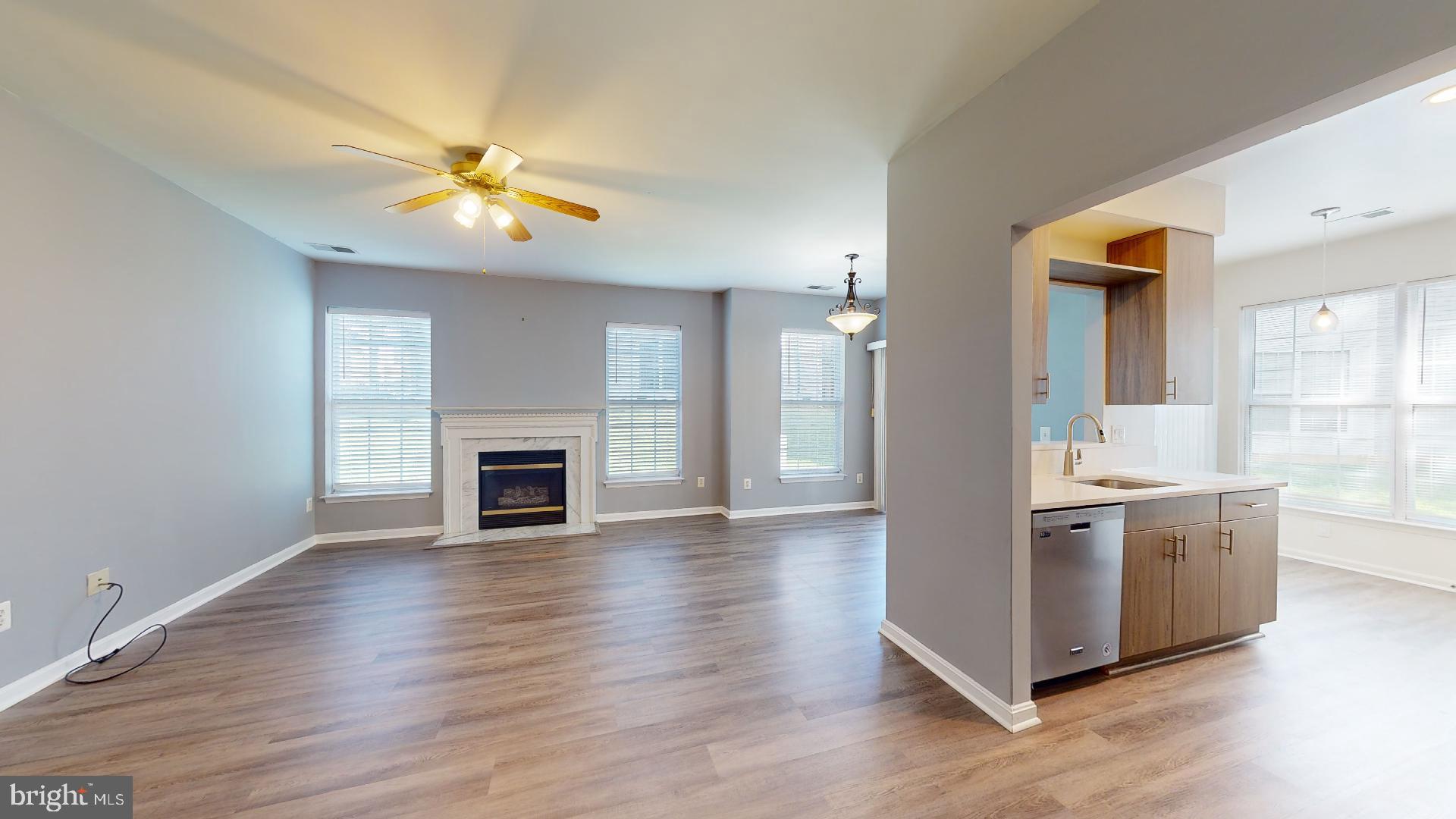 5947 Founders Hill Drive, Unit 103 Alexandria, VA 22310 - Photo 2 of 19 a view of a kitchen with a sink a fireplace and wooden floor