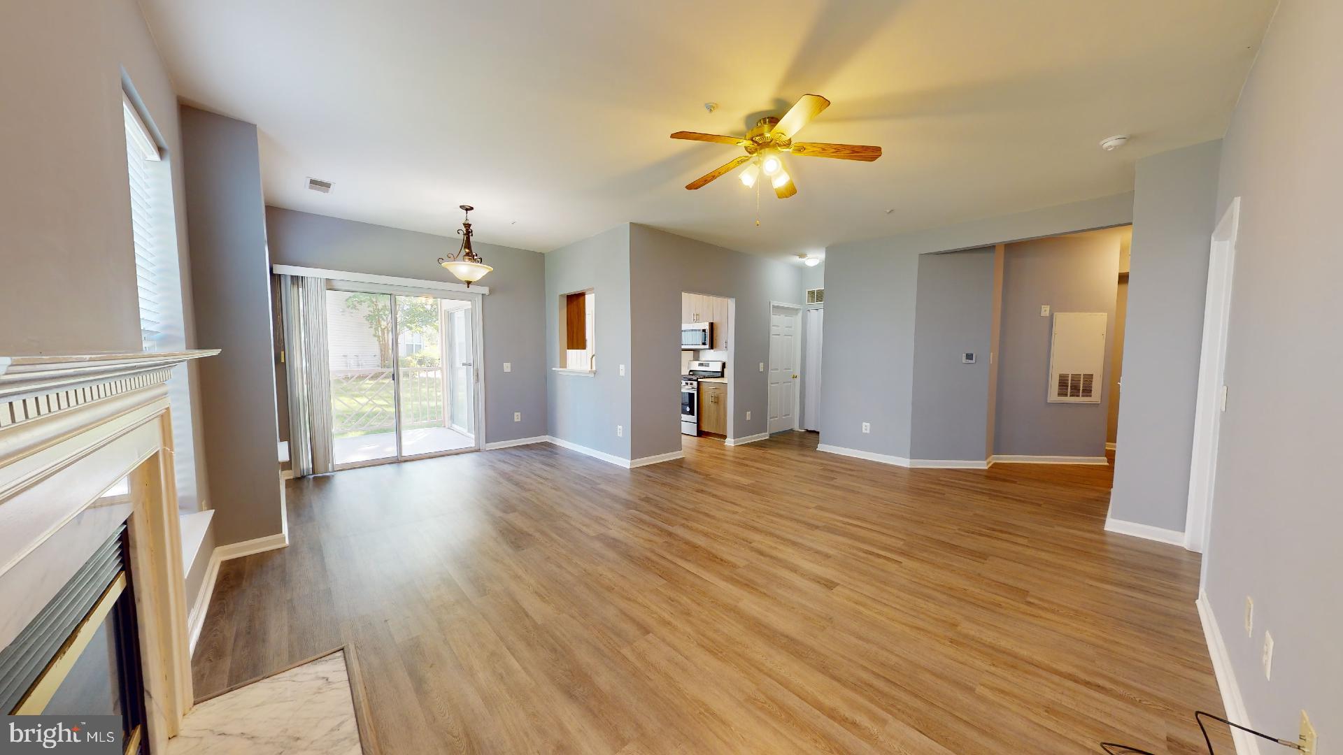 5947 Founders Hill Drive, Unit 103 Alexandria, VA 22310 - Photo 3 of 19 a view of an empty room with wooden floor and a window