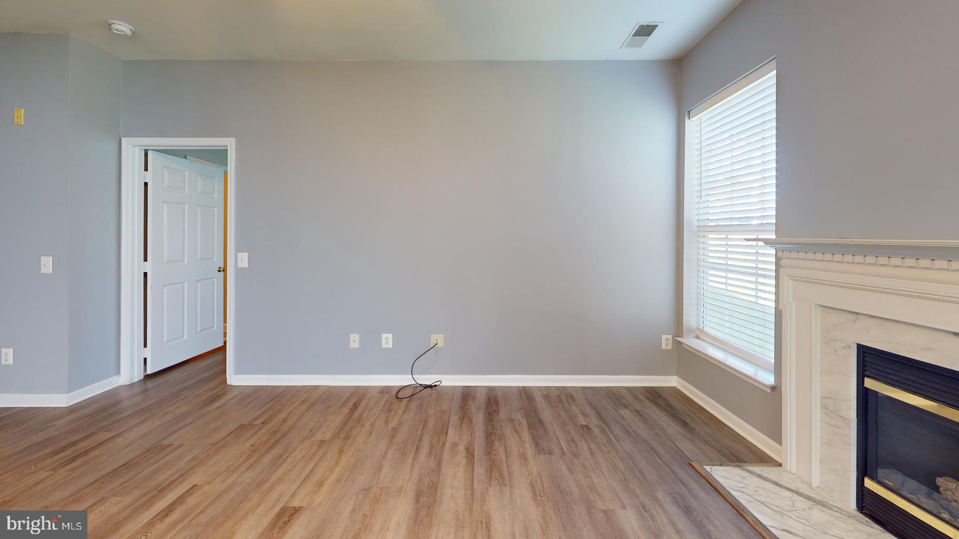 5947 Founders Hill Drive, Unit 103 Alexandria, VA 22310 - Photo 4 of 19 a view of livingroom with hardwood floor and window