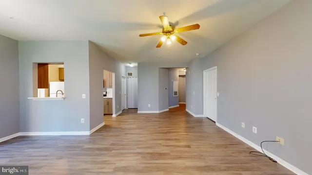 a view of empty room with wooden floor