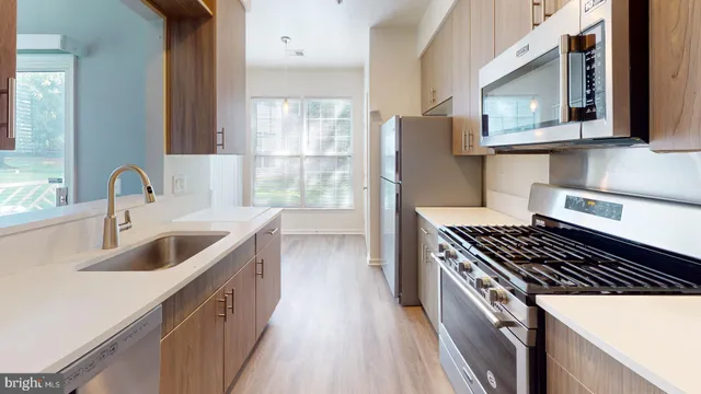 a kitchen that has a sink and a stove
