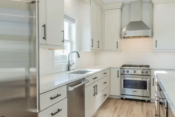 a kitchen with granite countertop white cabinets and white appliances