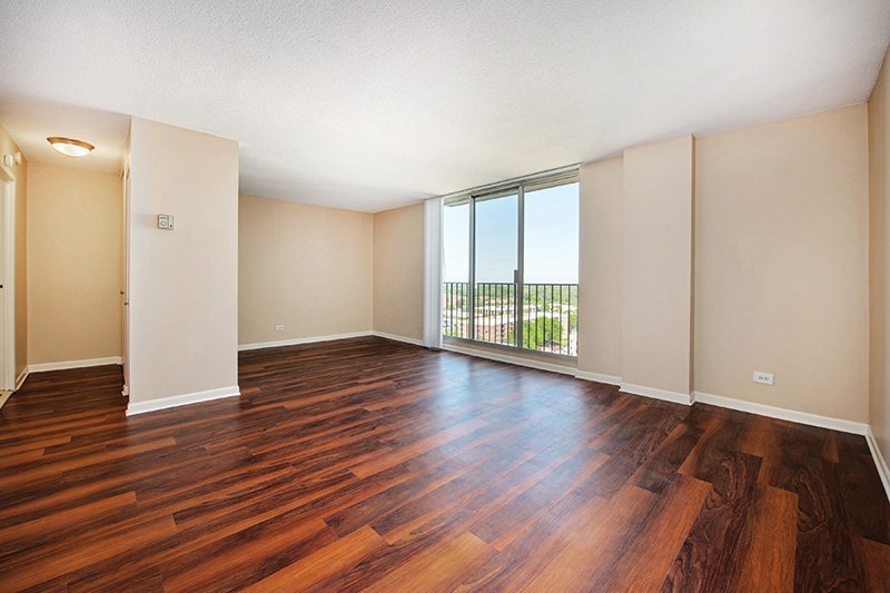 2233 South Highland Avenue, Unit H0605 Lombard, IL 60148 - Photo 3 of 8 a view of an empty room with wooden floor and a window