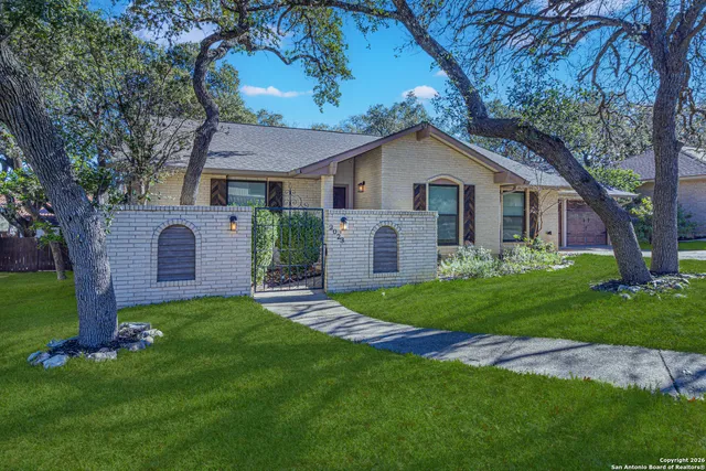 a front view of a house with a garden and yard