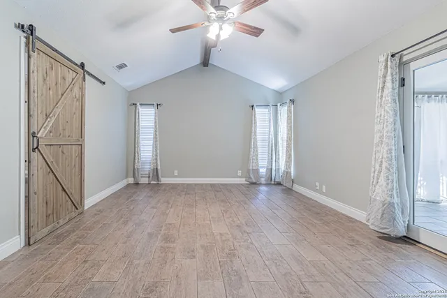 a bathroom with a granite countertop toilet sink and mirror
