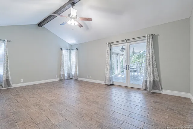 a bathroom with a granite countertop toilet a sink and a mirror