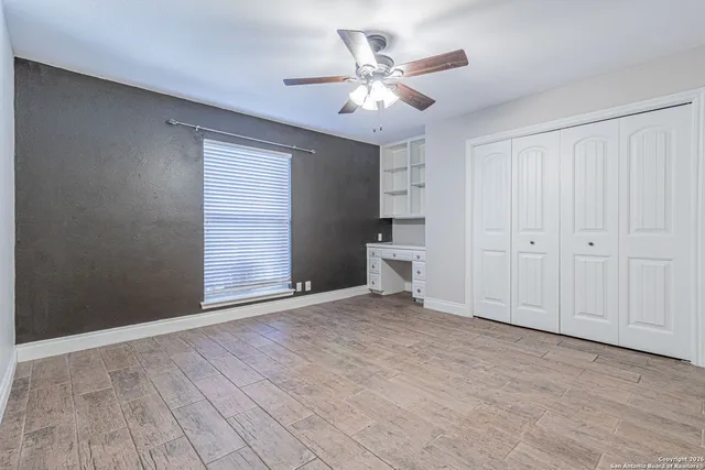 a view of a backyard with table and chairs and potted plants and large trees