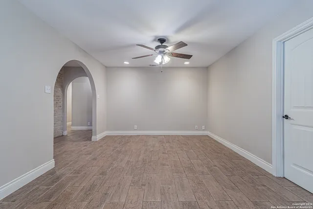 wooden floor in an empty room with a window