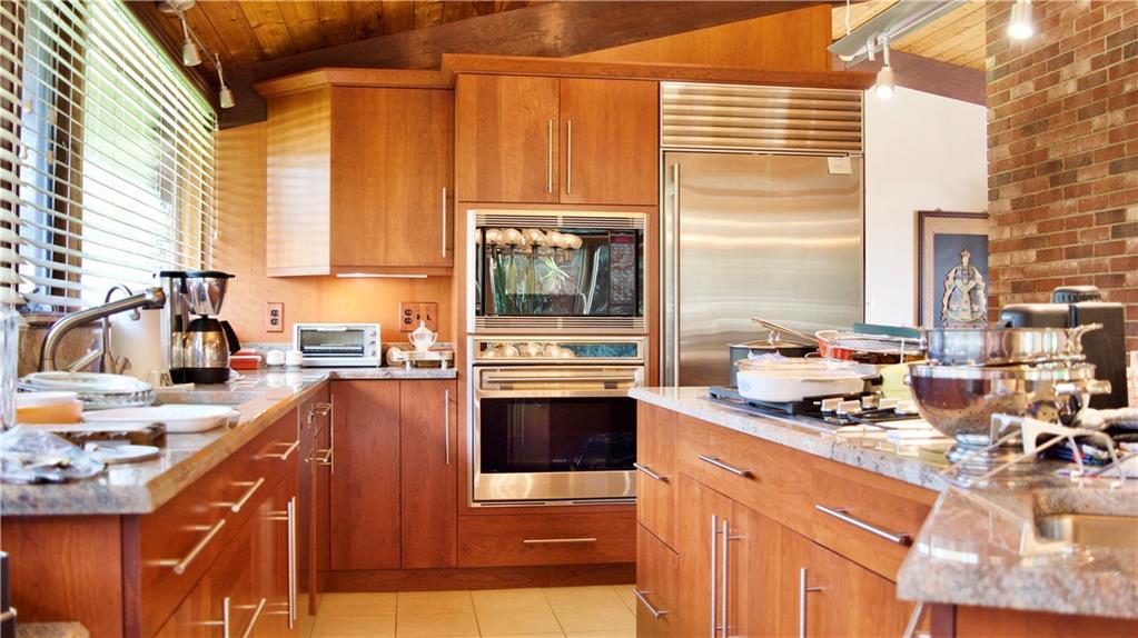 747 Beacon Road Robinson Township, PA 15205 - Photo 7 of 20 a kitchen with stainless steel appliances a stove sink and cabinets