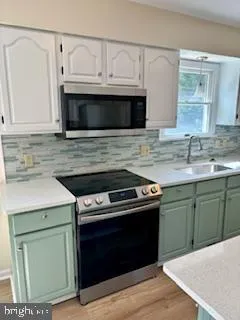 a kitchen with granite countertop a stove and a sink