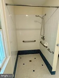 a bathroom with a shower and a shower