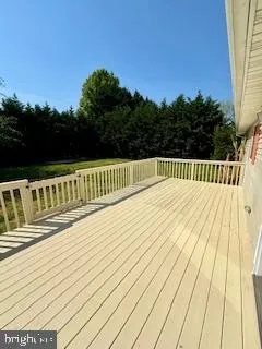 a view of balcony with wooden floor and fence