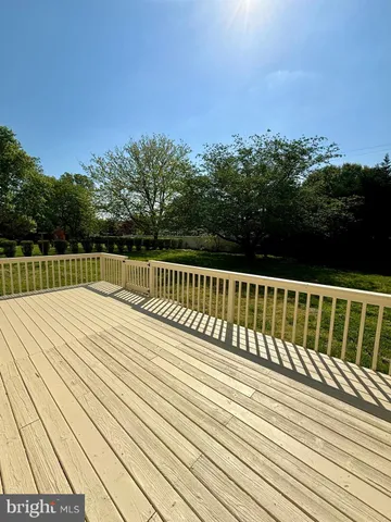 a view of balcony with wooden floor and fence