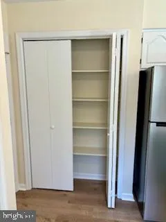 a view of walk in closet with empty racks