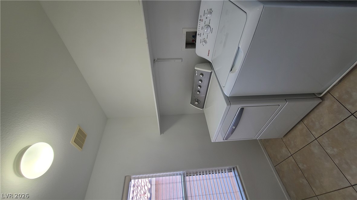 8944 Rutherford Grove Street Las Vegas, NV 89148 - Photo 28 of 35 Functional laundry space with a window offering natural light and convenient tile flooring.