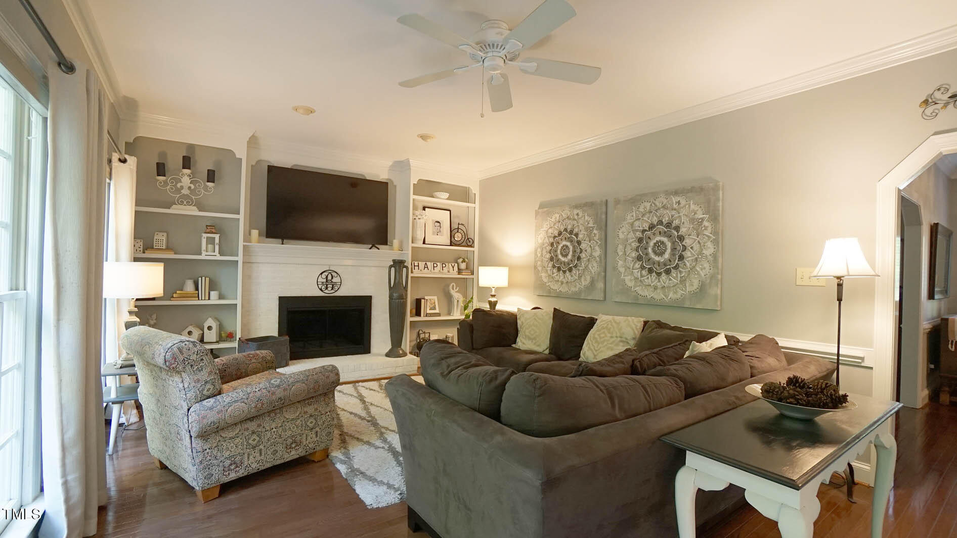 1505 Sharnbrook Court Raleigh, NC 27614 - Photo 23 of 67 a living room with furniture a fireplace and a flat screen tv