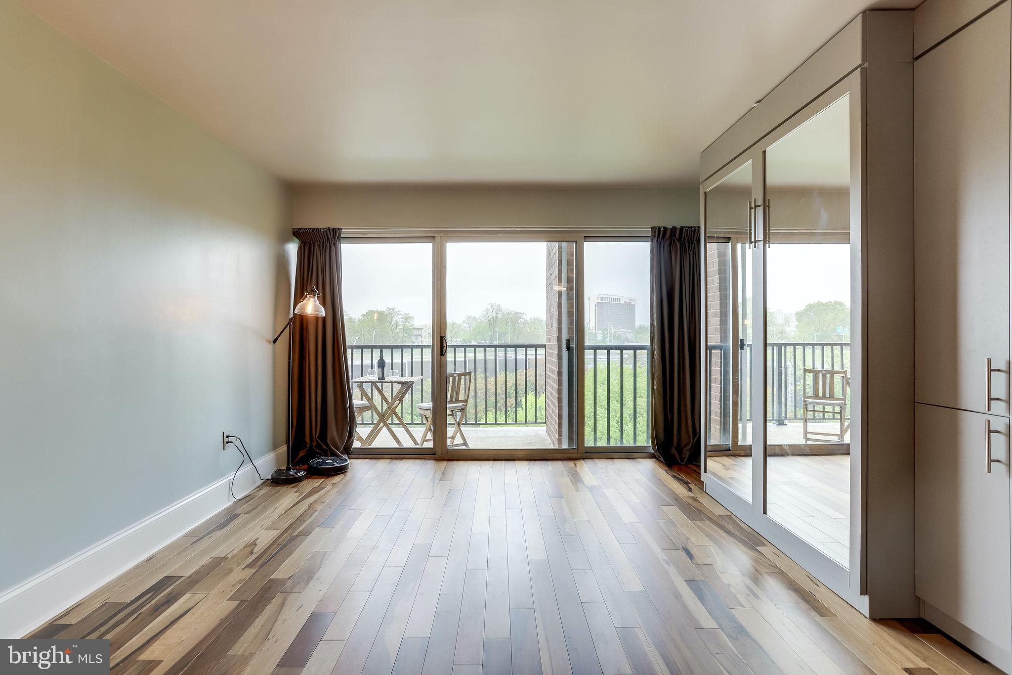 a view of a room with wooden floor and city view