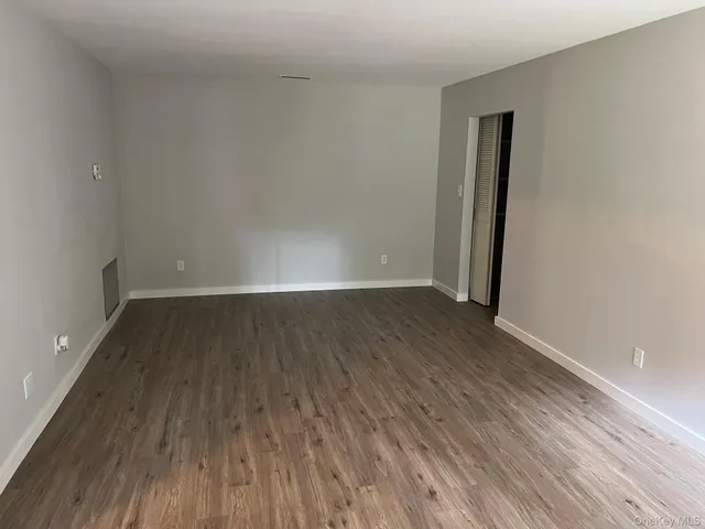 a view of a room with wooden floor
