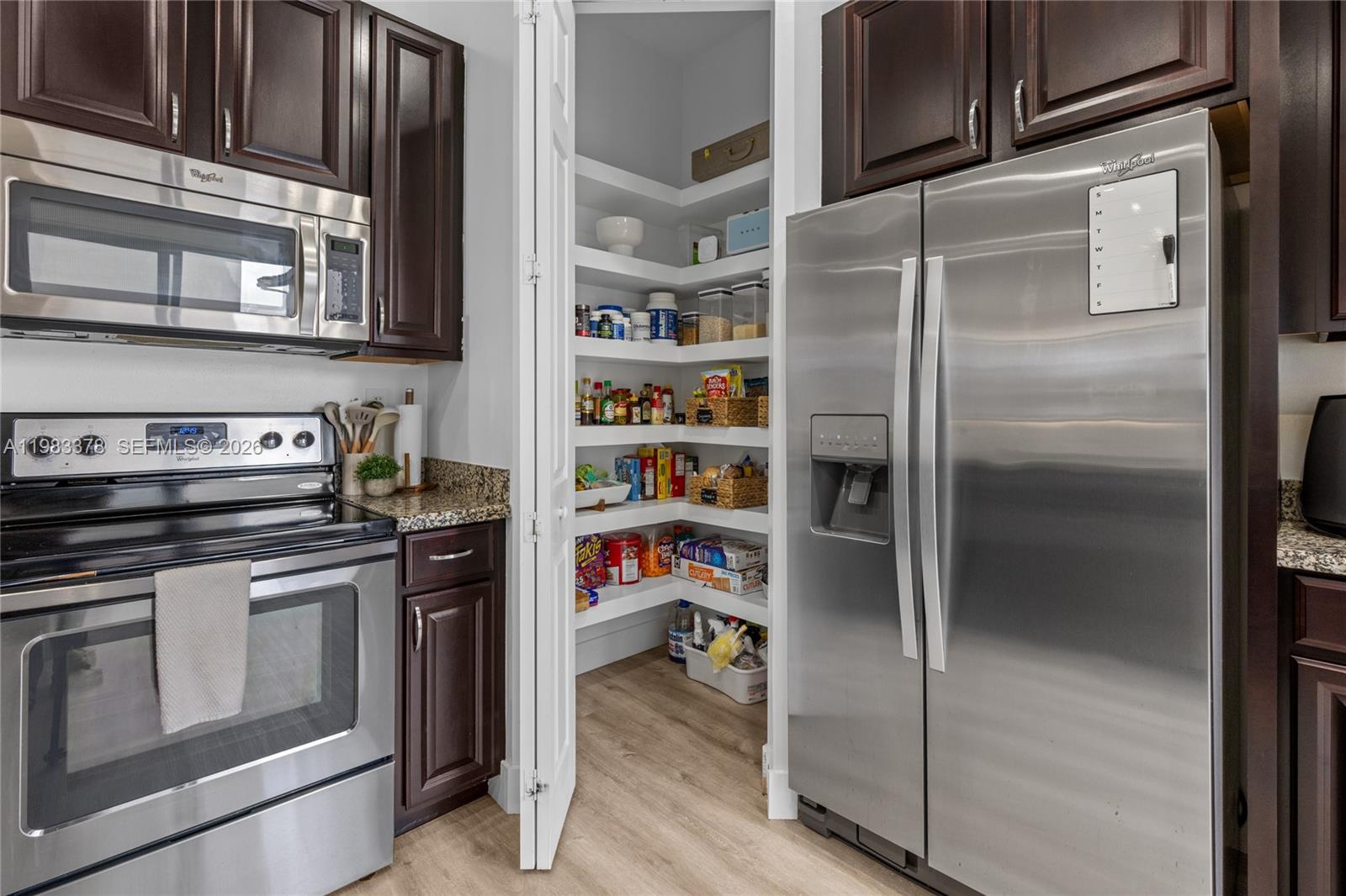 9094 Southwest 36th Street Miramar, FL 33025 - Photo 15 of 50 a kitchen with a refrigerator and a stove