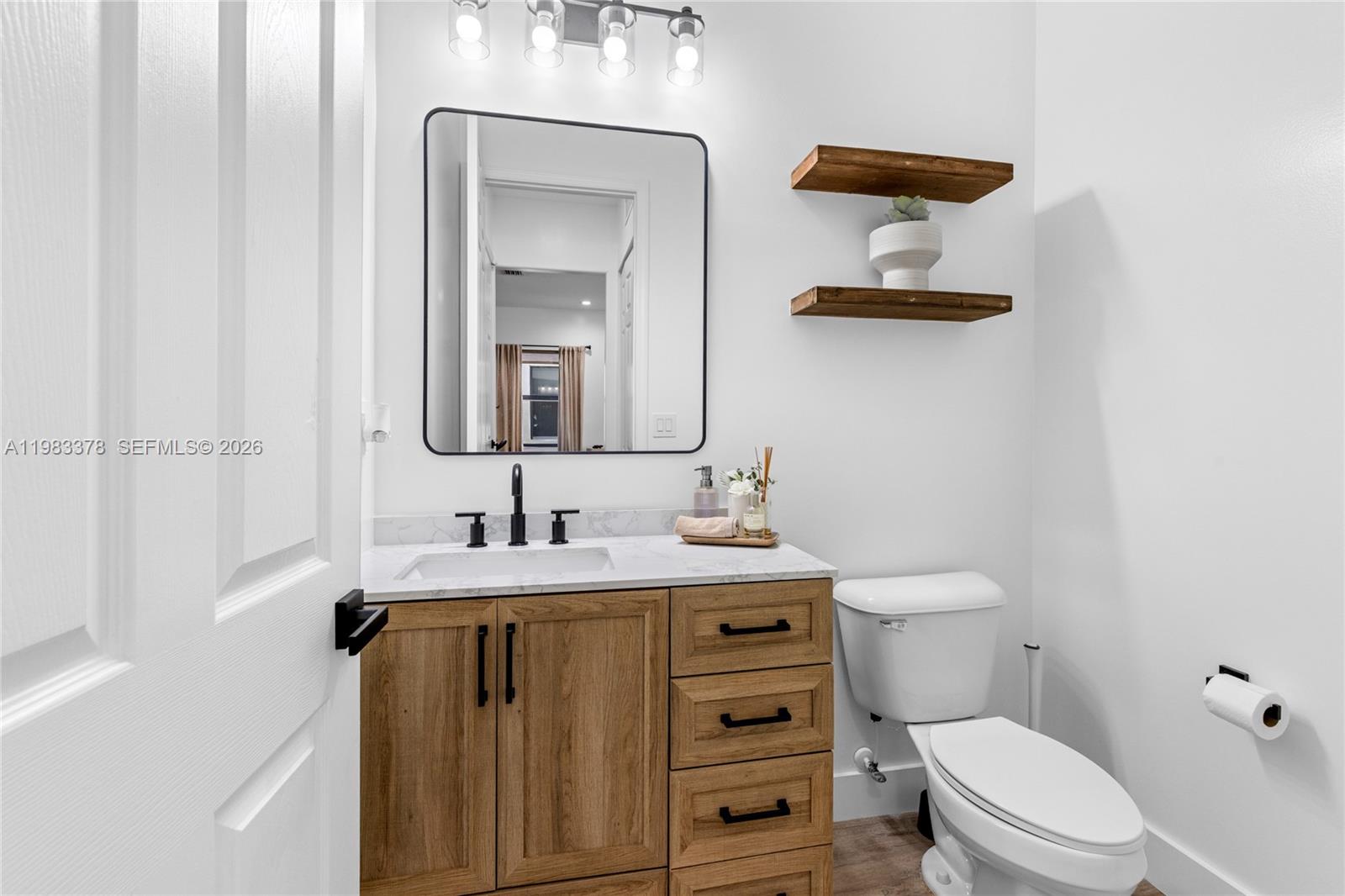 9094 Southwest 36th Street Miramar, FL 33025 - Photo 17 of 50 a bathroom with a toilet sink and mirror
