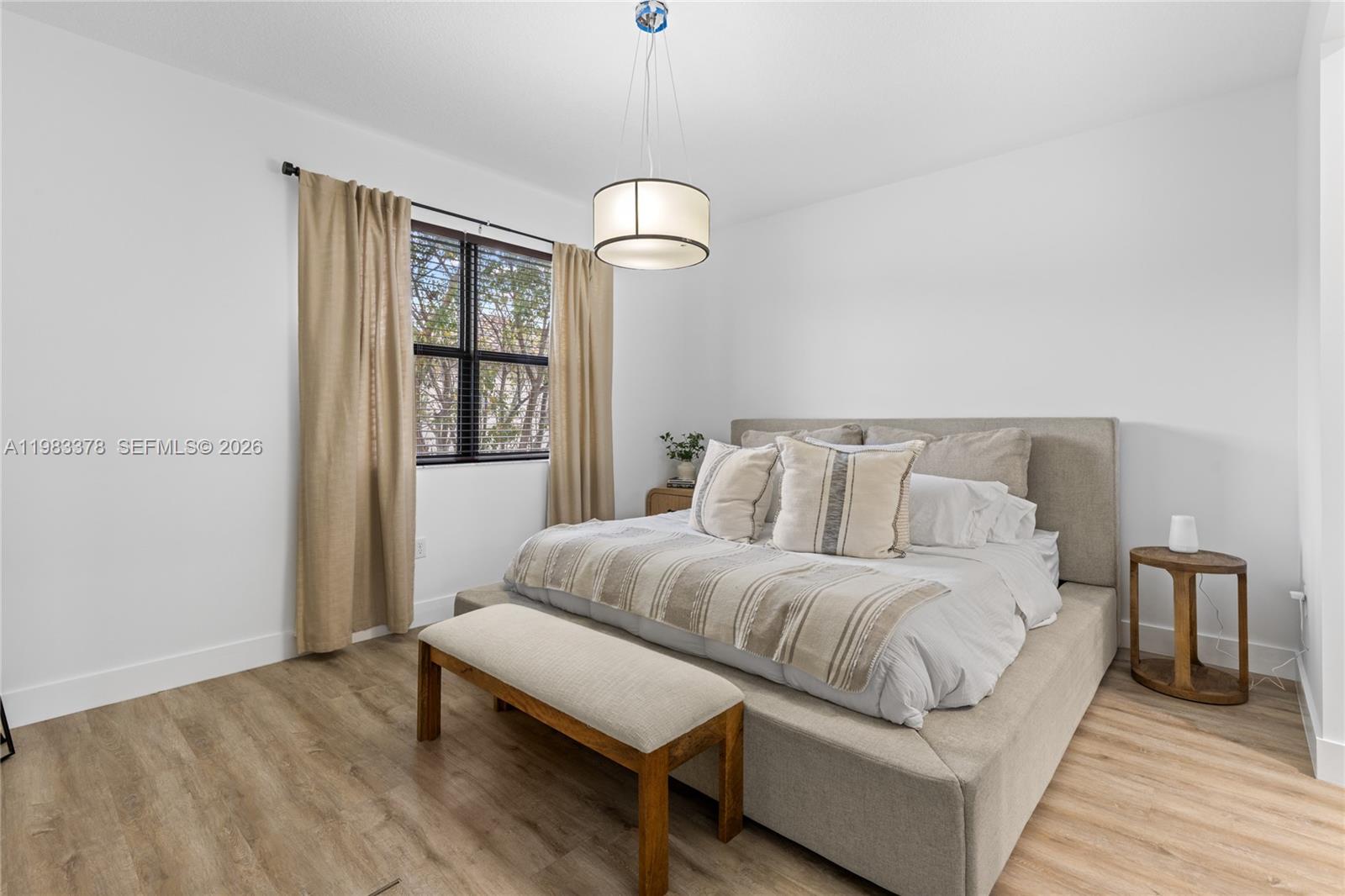 9094 Southwest 36th Street Miramar, FL 33025 - Photo 23 of 50 a spacious bedroom with a bed and wooden floor