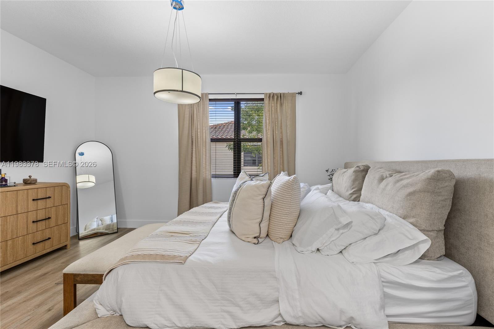 9094 Southwest 36th Street Miramar, FL 33025 - Photo 25 of 50 a bedroom with a bed and a flat screen tv