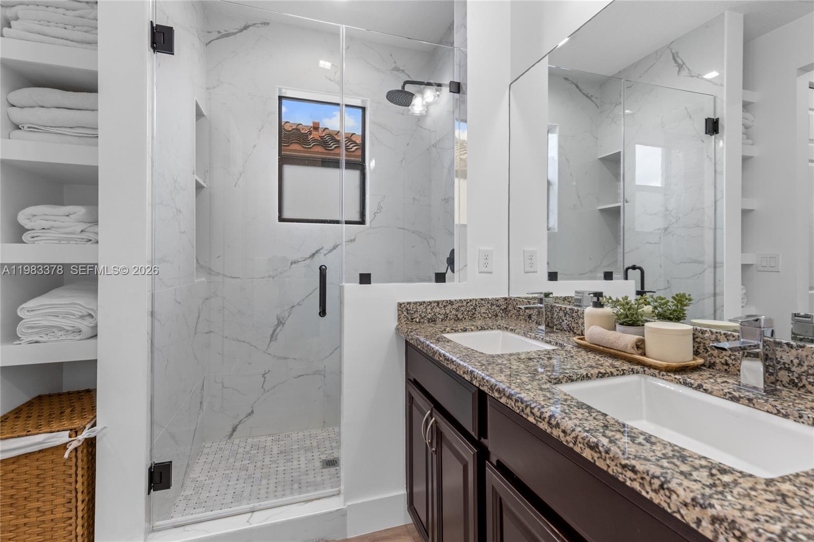 9094 Southwest 36th Street Miramar, FL 33025 - Photo 27 of 50 a bathroom with a granite countertop sink a mirror and shower