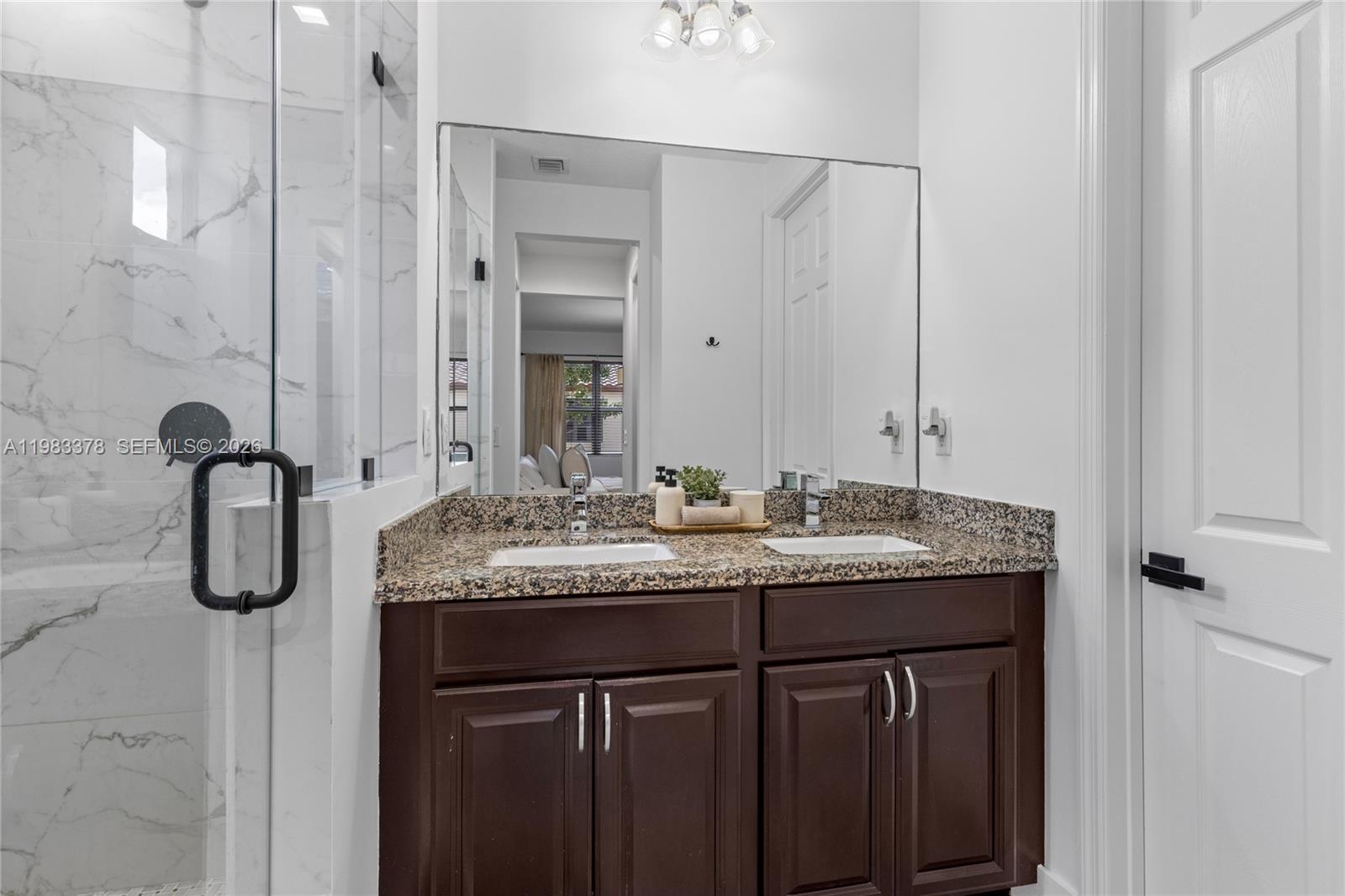 9094 Southwest 36th Street Miramar, FL 33025 - Photo 28 of 50 a bathroom with a granite countertop sink and a mirror
