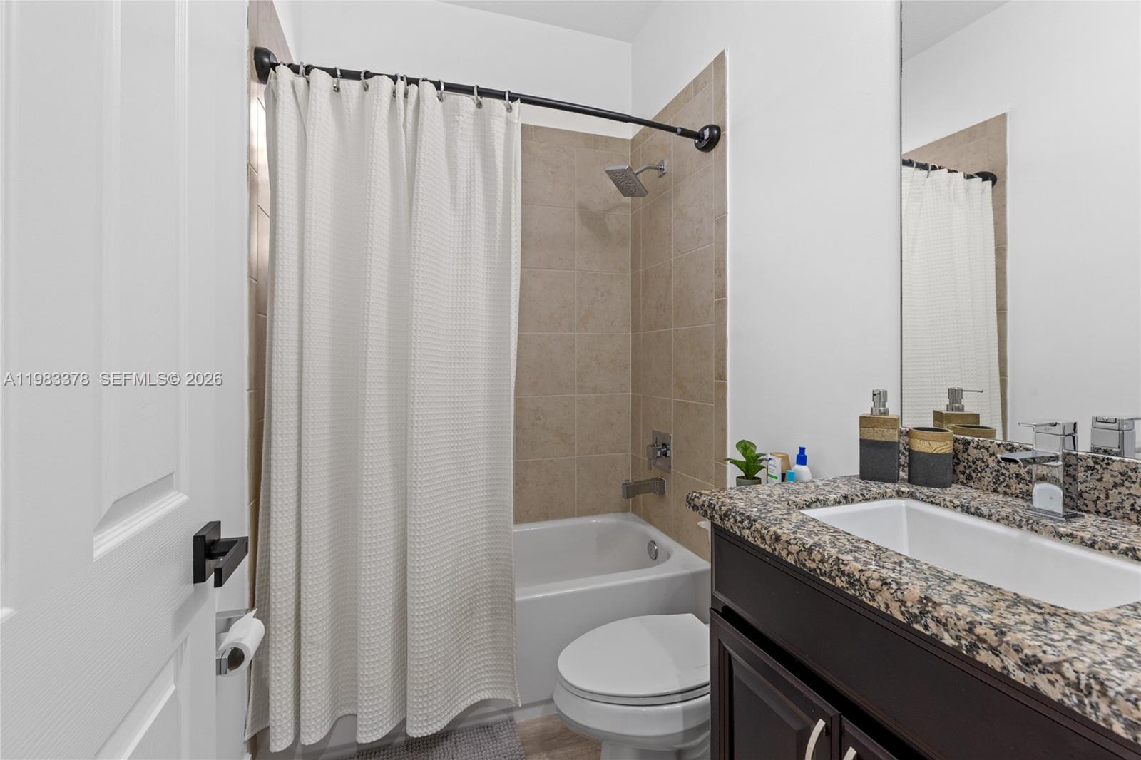 9094 Southwest 36th Street Miramar, FL 33025 - Photo 35 of 50 a bathroom with a granite countertop sink toilet and shower