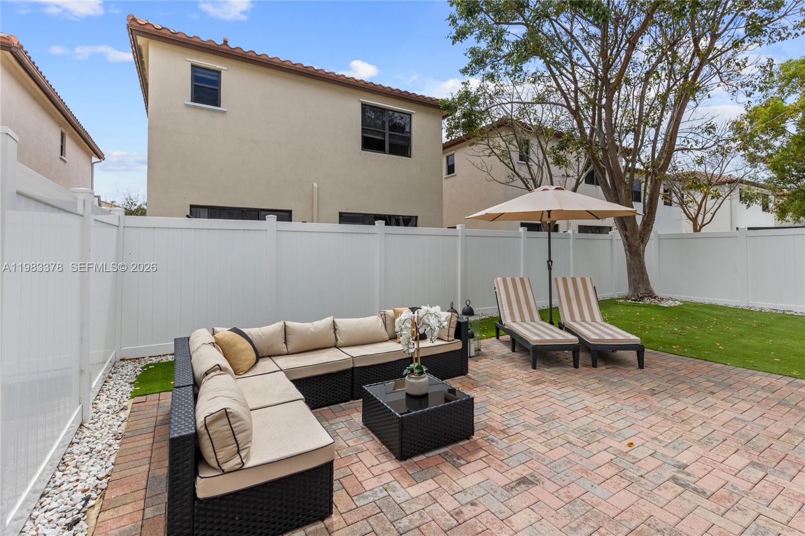 9094 Southwest 36th Street Miramar, FL 33025 - Photo 40 of 50 a backyard of a house with table and chairs