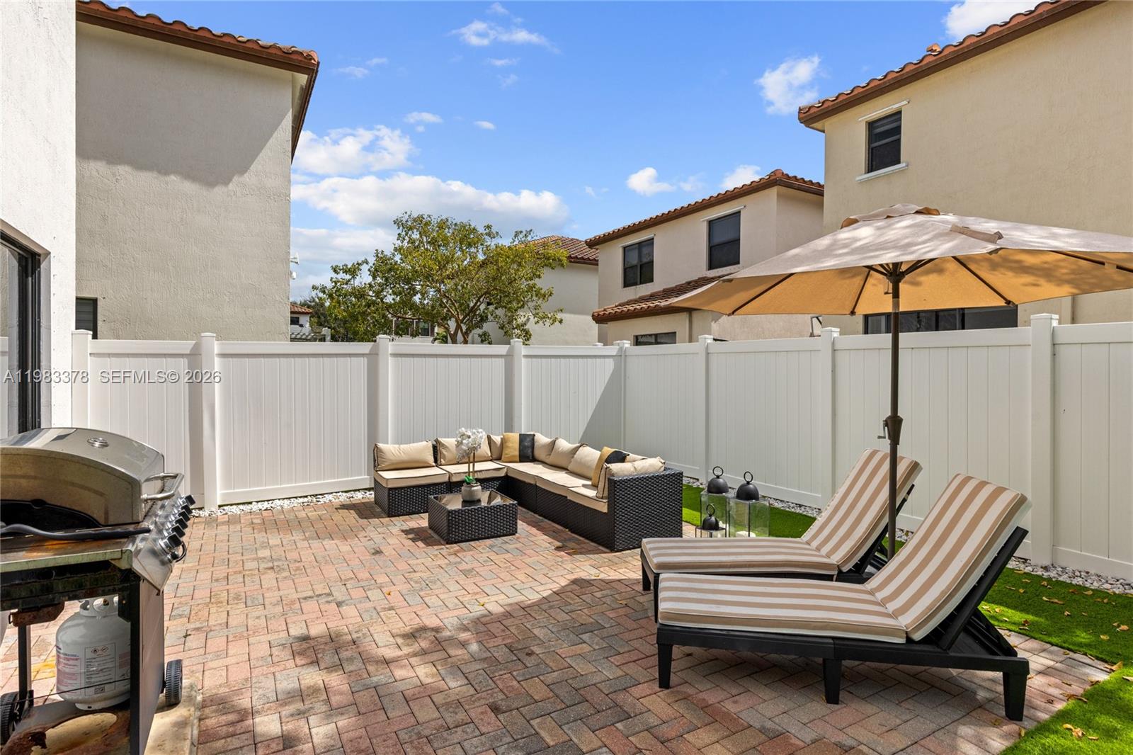 9094 Southwest 36th Street Miramar, FL 33025 - Photo 45 of 50 a backyard of a house with table and chairs