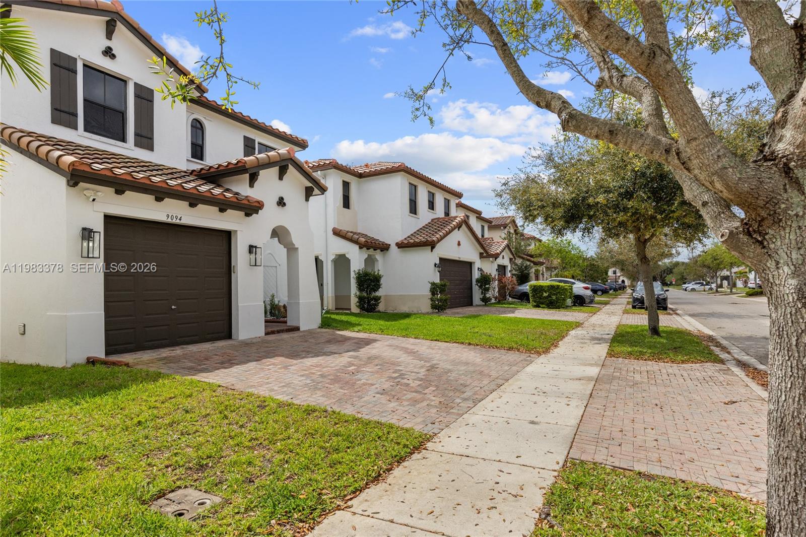 9094 Southwest 36th Street Miramar, FL 33025 - Photo 47 of 50 a view of a white house with a yard and potted plants