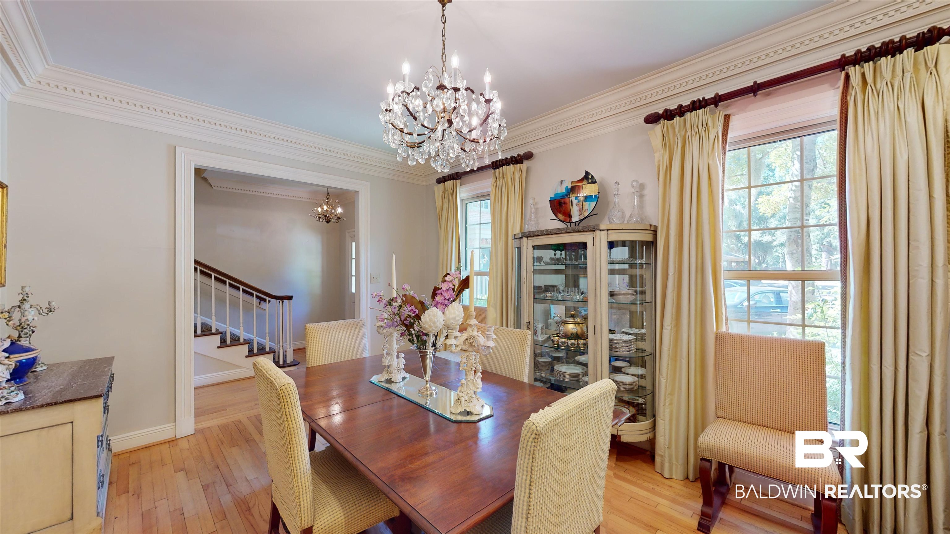 2404 Spring Hill Avenue, Unit 115 Mobile, AL 36607 - Photo 5 of 38 Dining space featuring an inviting chandelier, ornamental molding, and light wood-type flooring